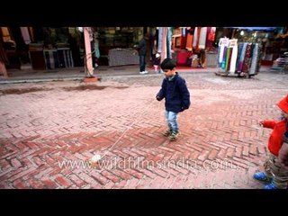 Children Playing with pull string toys at Dilli Haat