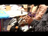 Toy seller playing with his goods at Hazrat Nizamuddin Dargah