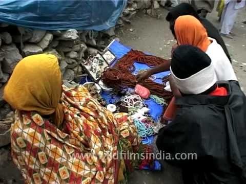 Pilgrims selecting their choice of Hindu prayer beads at Amarnath Yatra