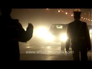 Vehicle headlights as it passes through Vijay Chowk near the President's House, Delhi