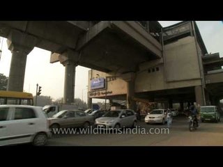 Vehicles passing below elevated Govindpuri metro station, Delhi