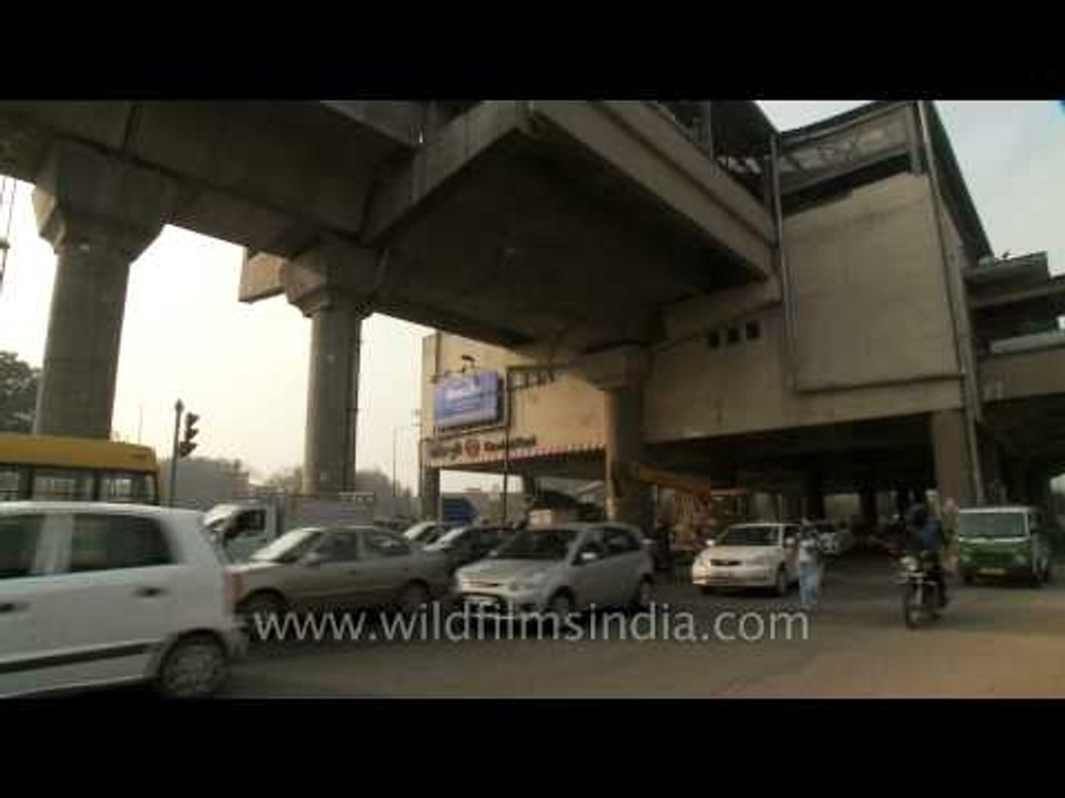 Vehicles passing below elevated Govindpuri metro station, Delhi