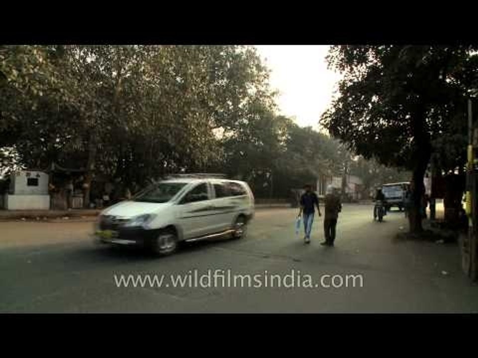 Vehicles crossing under the elevated metro tracks near Kalkaji Mandir metro station, Delhi