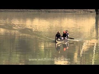 Three men taking a Boat ride at Doyang river, Nagaland