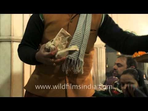 Hindu priest marks Lord Hanuman devotees with Tilak on forehead