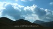 Time lapse of clouds moving above mountains - Dzukou Valley