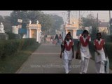 School students walk past Basilica of Our Lady Of Graces