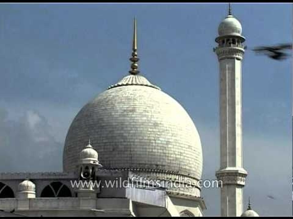 Pigeons fly over the Jama Mosque in Srinagar