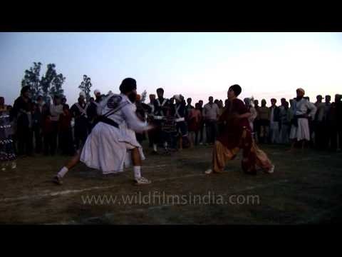 Sikhs playing Gatka with sword
