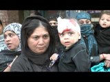 Shia woman carries a bleeding child after he was cut in the head during Ashoura day