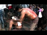 Wounded devotees nurse each other after flagellation for Muharram
