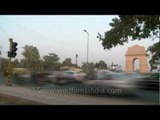 Traffic of Delhi in quick motion with India Gate in back-drop