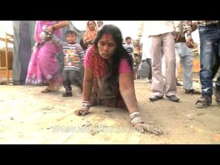 Female devotee crawling towards ghat during Chatt Puja