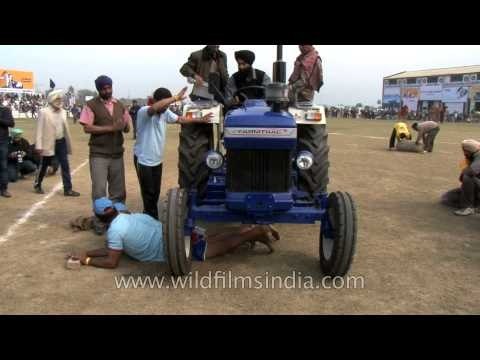 Life threatening sport - men crushed under a tractor at Kila Raipur