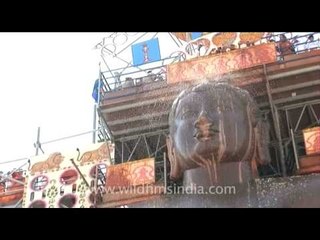 Pouring holy offerings over Lord Bahubali's forehead at Mahamastakabhisheka