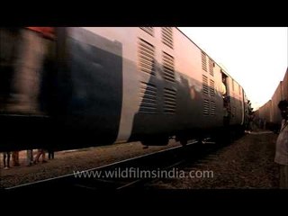 Black smoke billowing out of the engine in an Indian rail