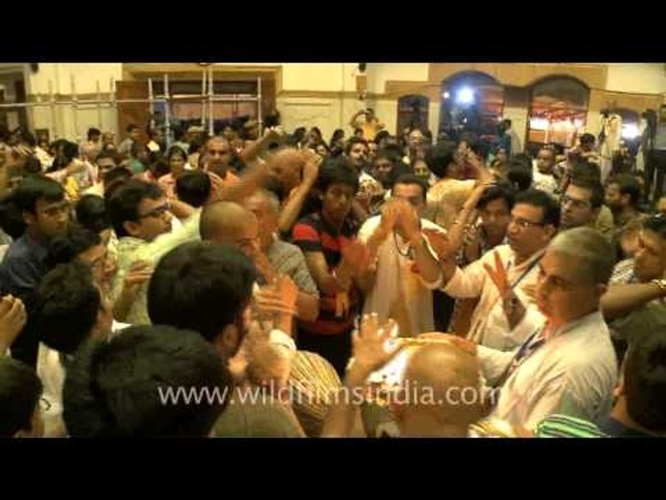 Lord Krishna's devotees in Iskcon mandir with sadhu and aarti