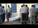 Family placing dead body on pyre for cremation