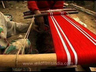 Lotha Naga ladies stretching yarns on their loin looms