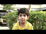 Child in a mango coloured tee at the mango festival