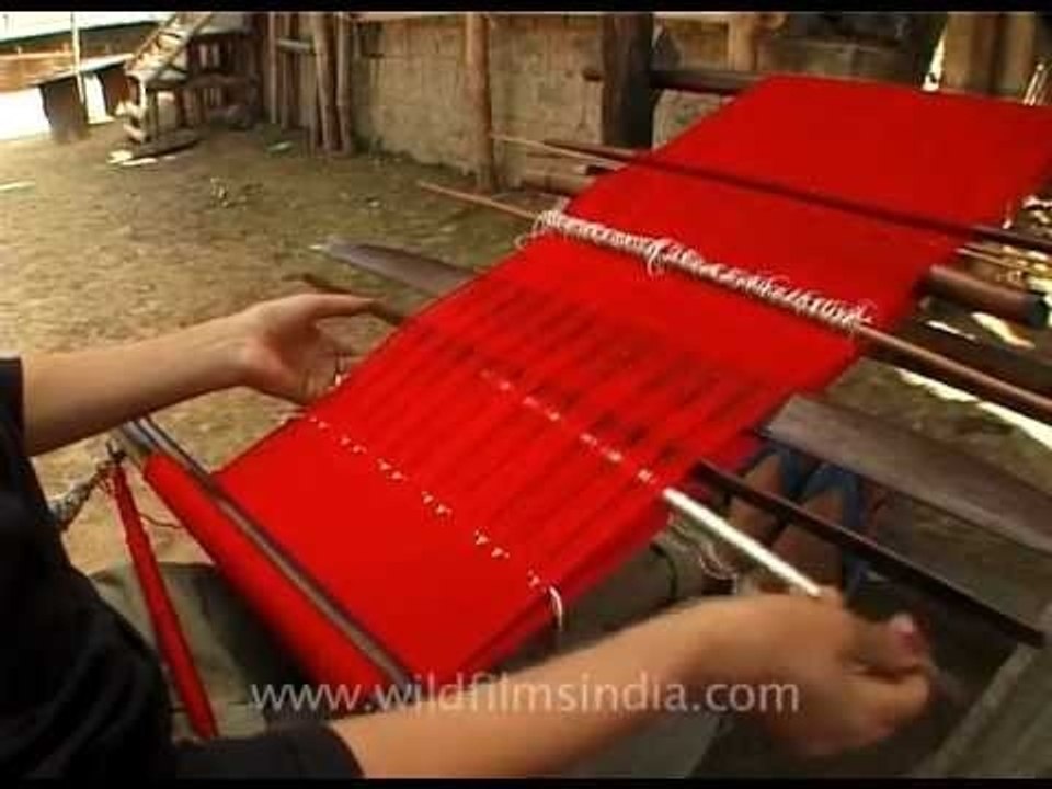 Traditional weaving of red Naga sarong, Longsa...