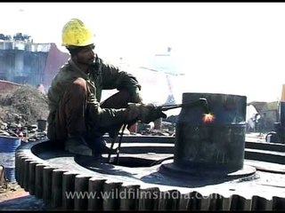 Welding at the ship recycling yard in Alang