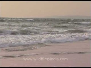 White sea waves splashing on Goa shores