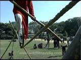 Man swings on rope with a bicycle tyre hub!