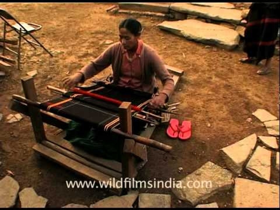 North East Indian women weaving a traditional s...