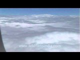 View up above from a plane cutting across the clouds