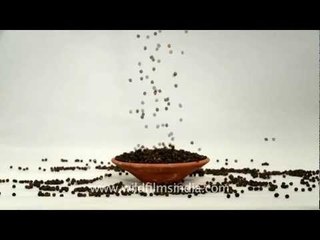 Black pepper falling on a clay plate!