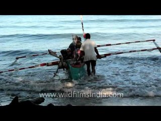 Fishermen setting up sail, Indonesia