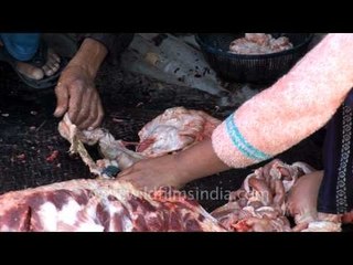 Pork intestines being cut into pieces