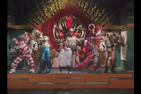 A dog monster turns into a trumpet playing dwarf and turns other monsters into random people who play instruments