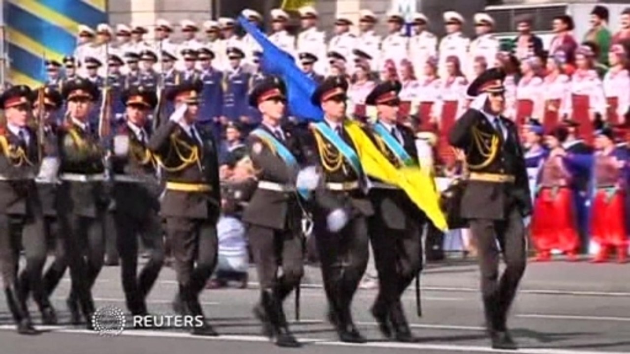 Ukraine defiant on national day, rebels parade captured soldiers