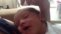 Adorable baby smiles for the first time
