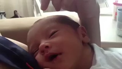 Adorable baby smiles for the first time