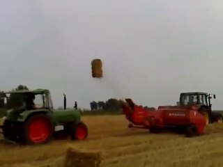 The tractor and the flying bales of hay