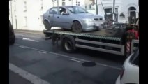 Crazy Driver crashing his car stuck on a tow truck!
