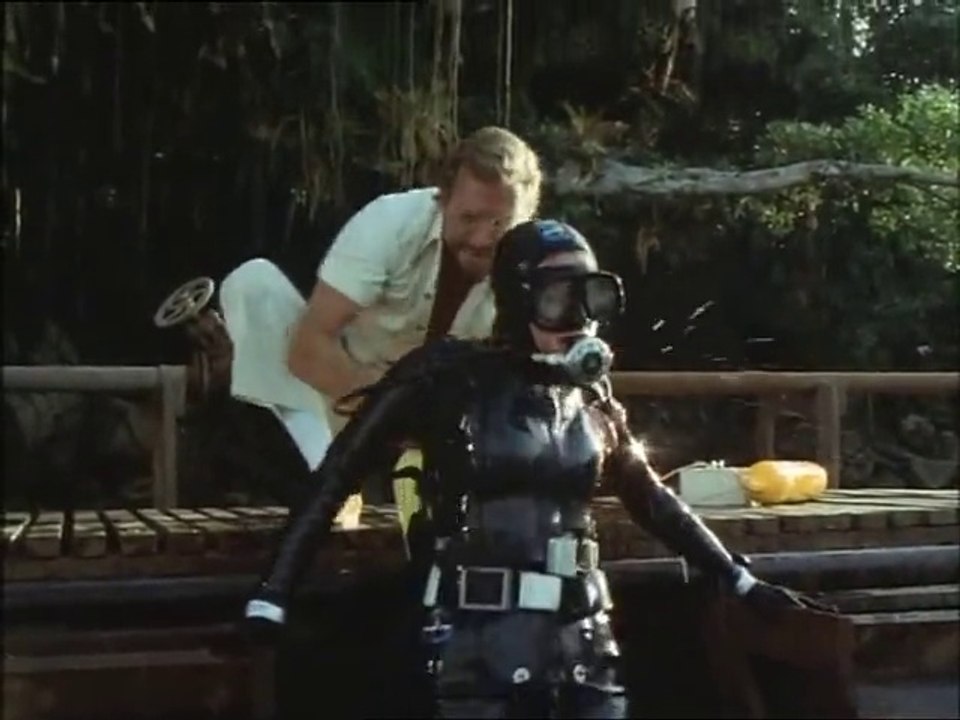 A woman in a rubber wetsuit meets some evil fish [Piranha]