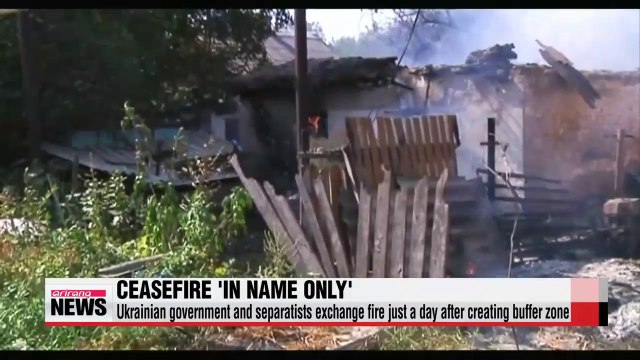 Ukrainian government and separatists exchange fire just a day after creating buffer zone