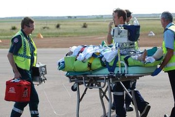 Shark attack victim : Sean Pollard is stretchered on to a RFDS plane.