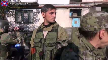 Ukrainian soldier smoking during bomb explosion.