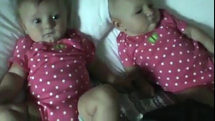 A lovely twin babies making each other laugh