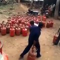 Dangerous method to load Gas cylinders on a truck... Indians are crazy!