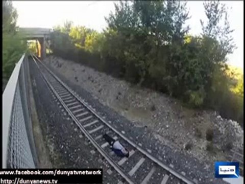 Italian teen lays between tracks and lets speeding train race over him