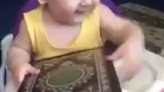 Cute Baby Showing His Love To Quran Pak