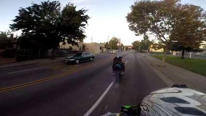 Insane motorcyclist plays chicken with on coming cars while doing smokey burnout