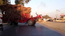 How is he steering the tractor? the front wheels are up.....