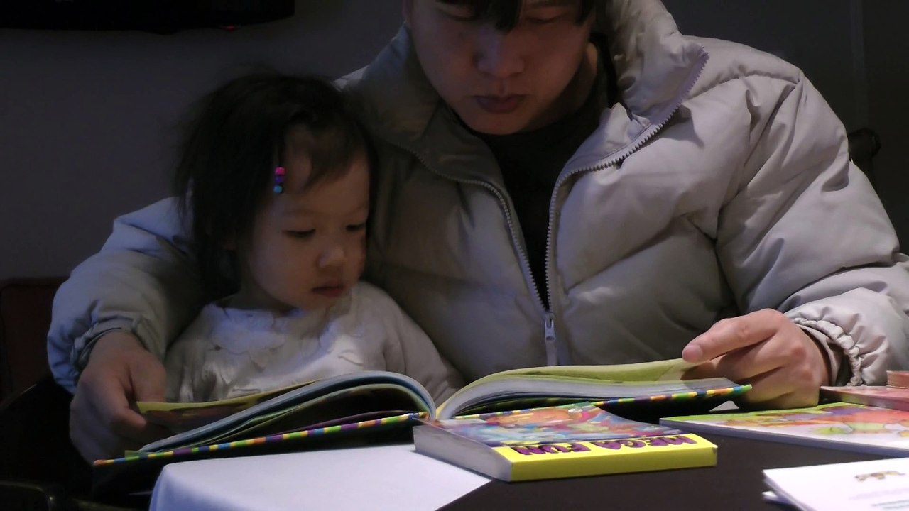 Girl Reading Dora The Explorer